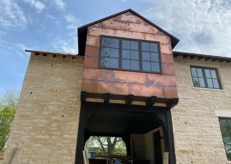 Copper metal panel facade on a stone building for Skylight Installation in Manalapan